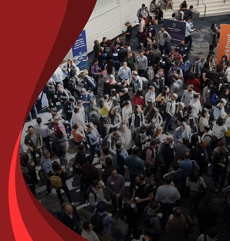 Conference attendees networking around sponsor booths.